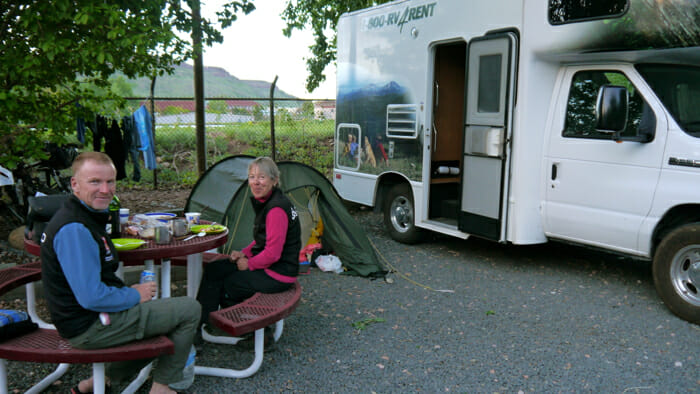 couple at picnic table next to rv