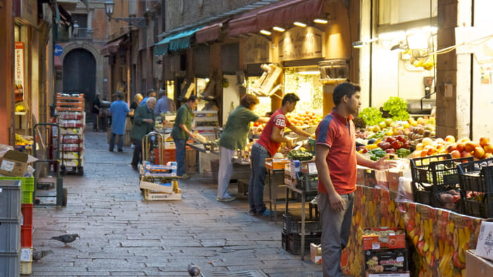 The original market in Bologna is on the Via de Drapperie. You can still go there for fine food. Here the vendors are preparing for day.