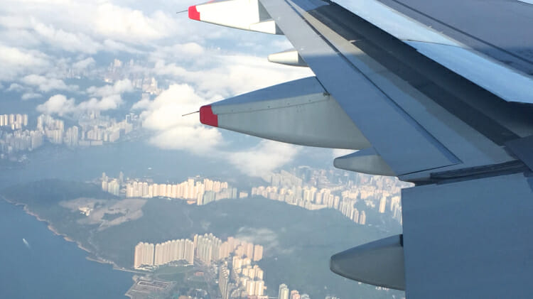 plane wing with city below