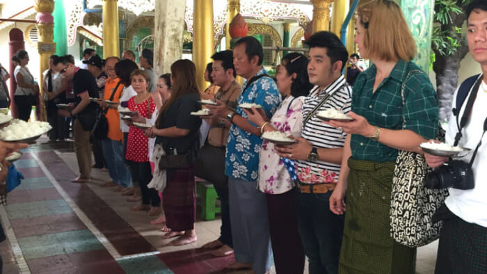 People waiting for the monks to give them rice and gifts