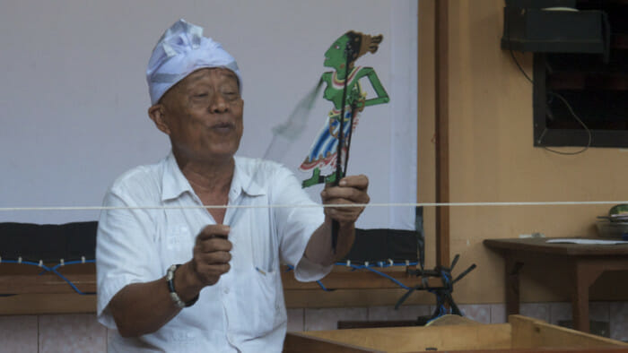 Shadow puppets, or wayang, is the most popular form of theater in Bali. Here the puppet master is at work.