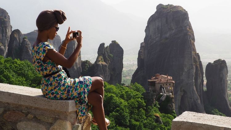 woman taking travel photo safe solo travel