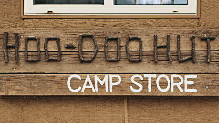 sign  for camp store in writing on stone 