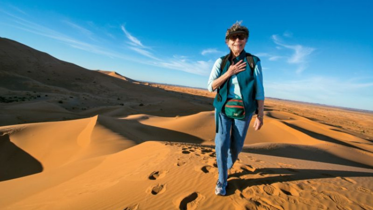 return to solo travel, overseas adventure travel, woman in desert