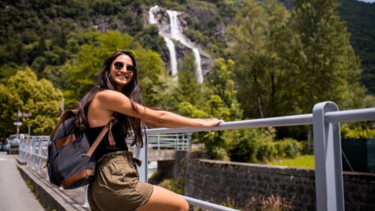 woman with backpack, waterfall