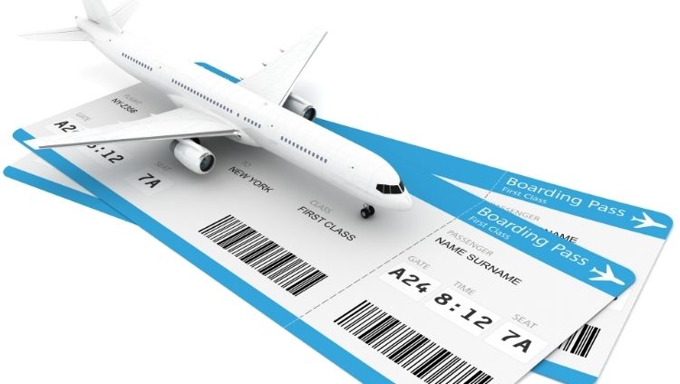 toy airplane sitting on flight tickets