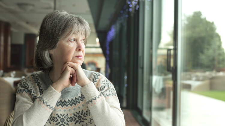 woman staring out window