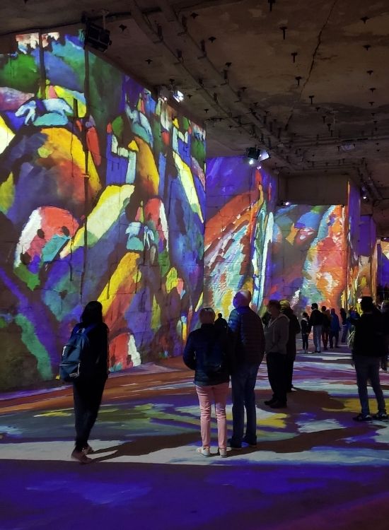 Guests watch and listen in silence at Carrières de Lumières.