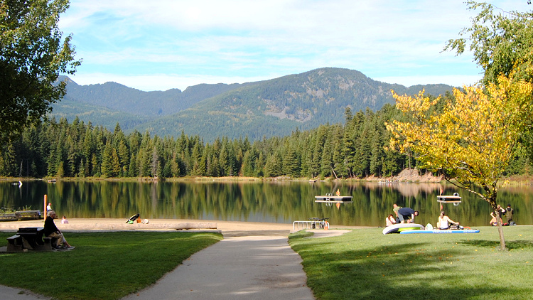 The shore of Lost Lake is a perfect spot for a solo traveler to pause and take in Whistler's landscape.