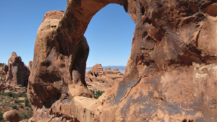 Peering through the rock at Arches National Park.