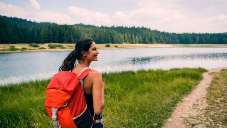 young woman on hiking path supported with tips from seasoned solo travelers 