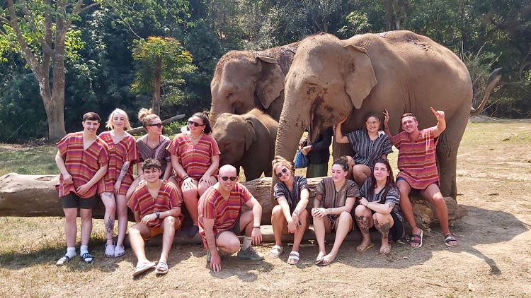 Bree Woolard with other travelers and elephants in Thailand