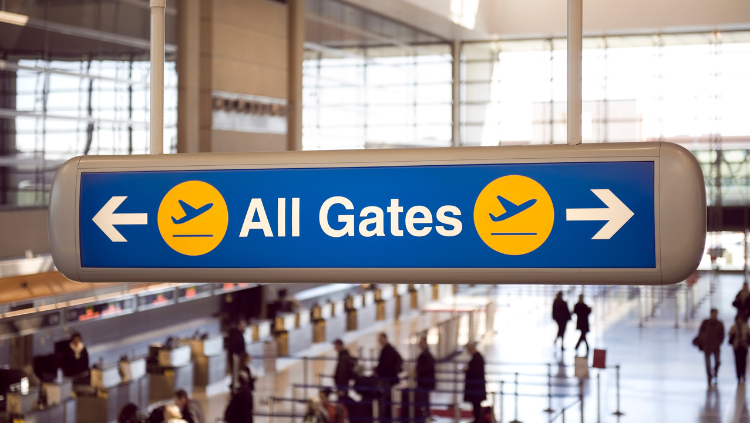sign pointing to gates in airport