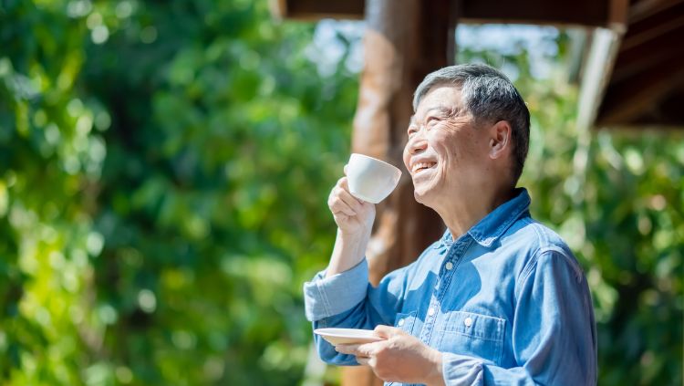 man drinking tea in the sun