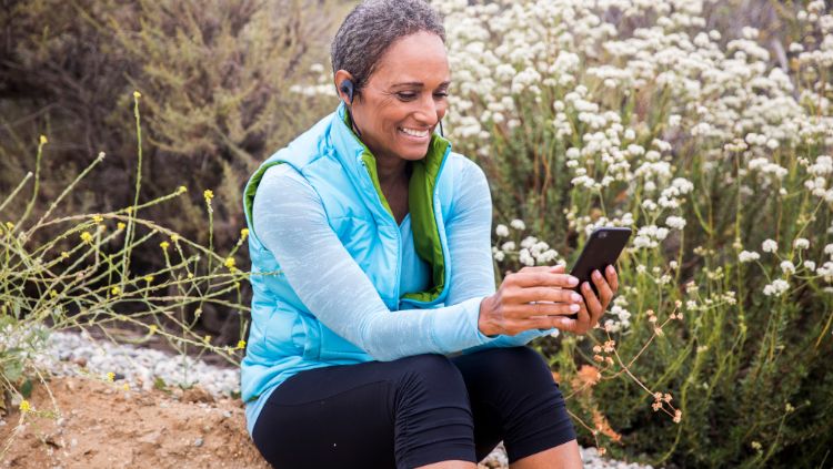 woman in nature looking at cellphone