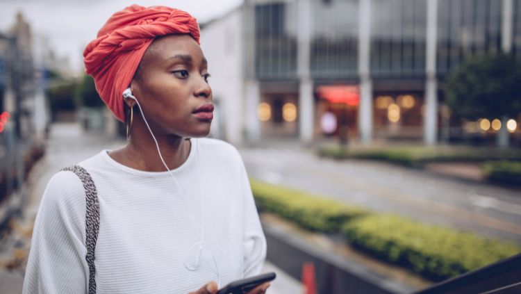 woman on street with earphones on