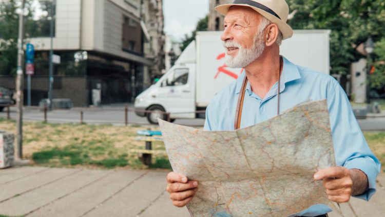 man on street holding a map