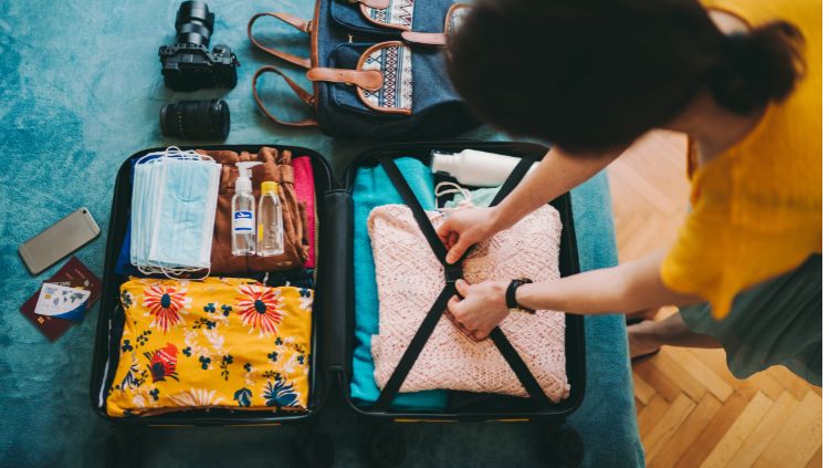 image, Woman packing suitcase, carry on packing list