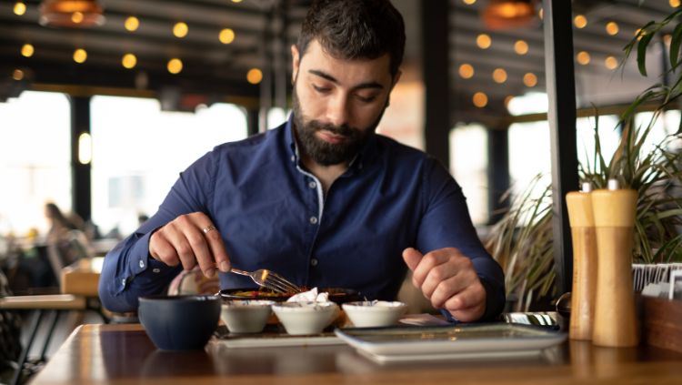 female traveler dining alone on outdoor patio