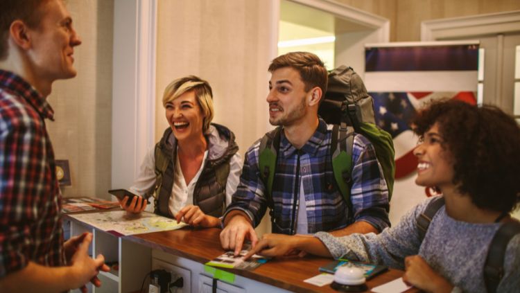 young travelers at hostel reception desk