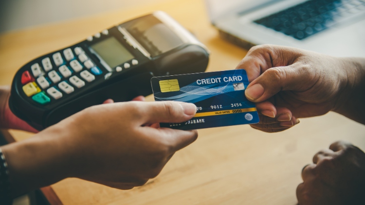 customer handing credit card to server