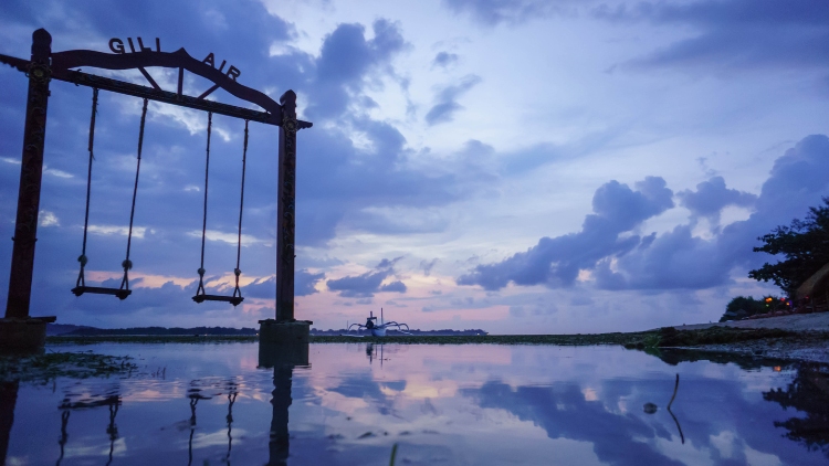 swings over the water at twilight in gili air