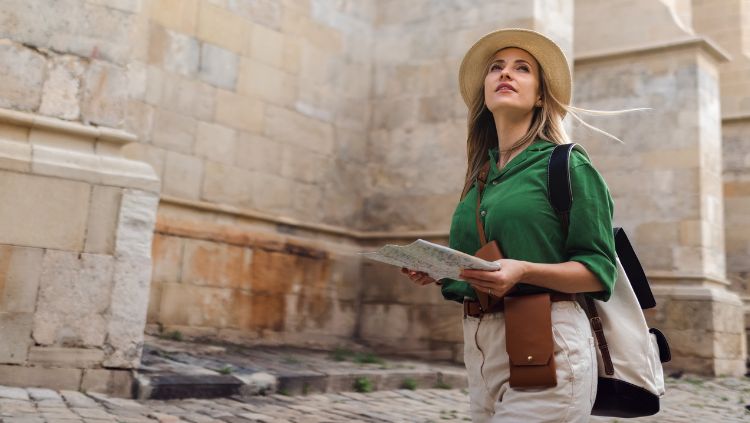 Female traveler holding a map and spending a day alone while traveling