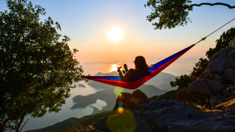 woman in hammock watching sunset