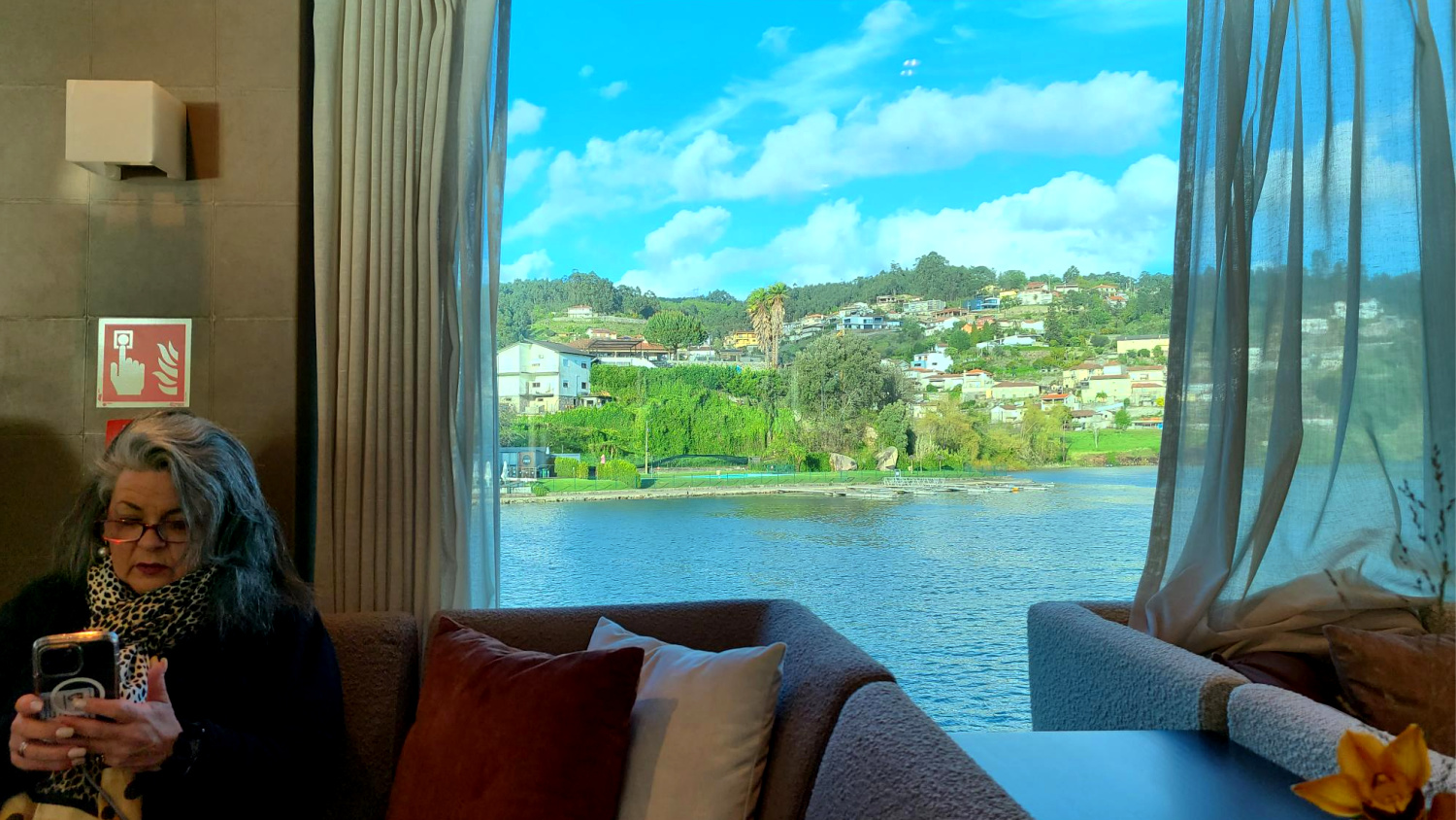 A solo traveler enjoys this river cruise in the panorama lounge.