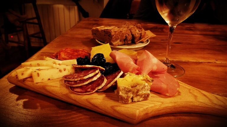 charcuterie board and glass of wine